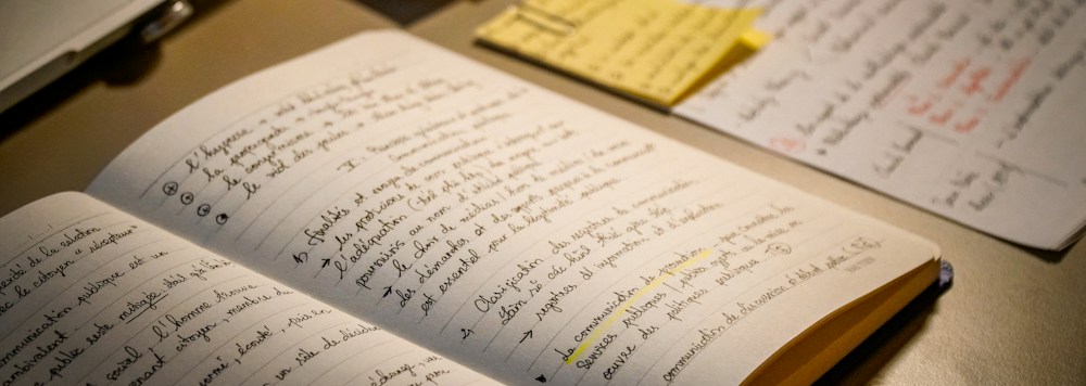 An open notebook filled with handwritten study notes